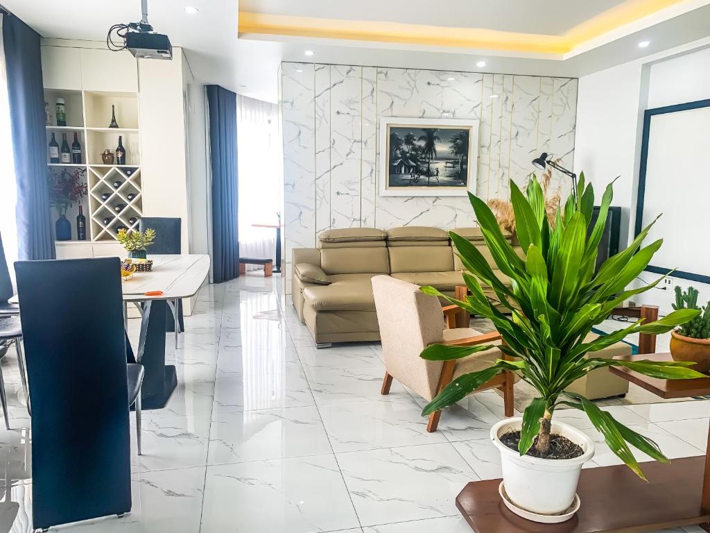 a living room with a couch and a table with a plant at Green Line Long Bien - Serviced Apartment - Ngoc Thuy - Hanoi in Hanoi