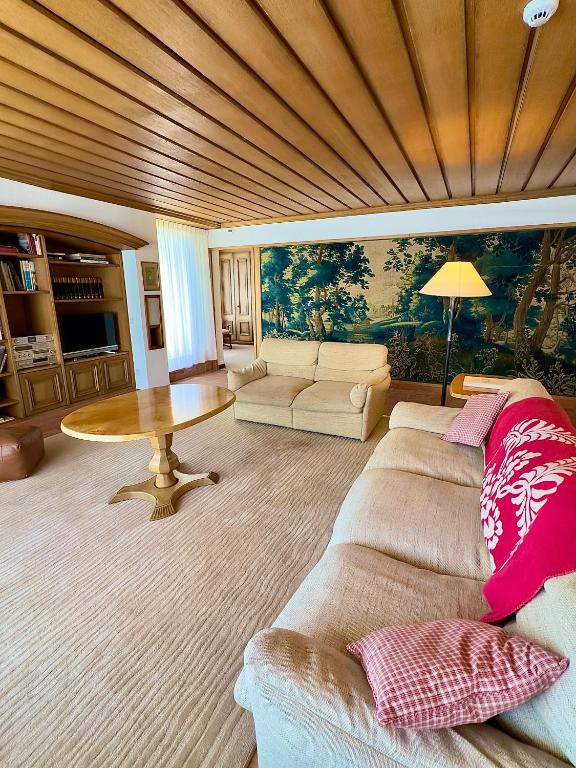 a living room with a couch and a table at Crystal Hotel superior in St. Moritz
