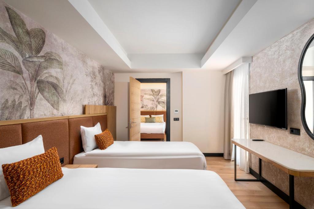 Postel nebo postele na pokoji v ubytování VOX MARIS RESORT