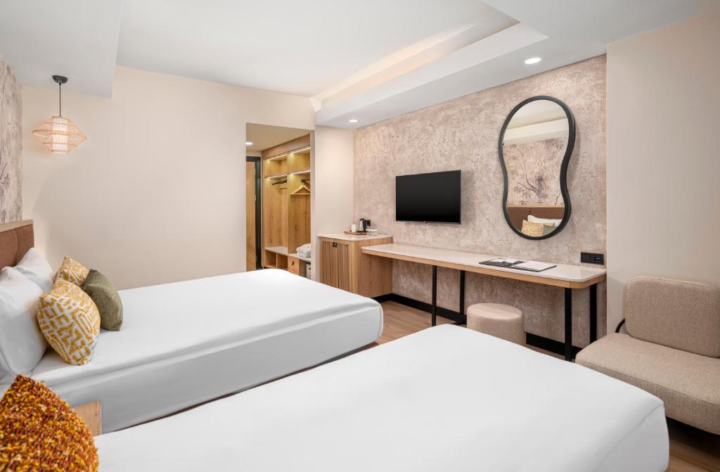 Postel nebo postele na pokoji v ubytování VOX MARIS RESORT