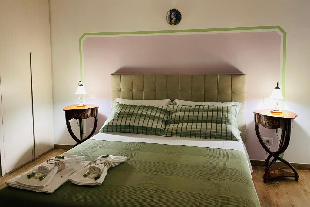a bedroom with a bed with two pairs of shoes on it at Alloggio Turistico San Valentino 5,8 in Poggio Mirteto