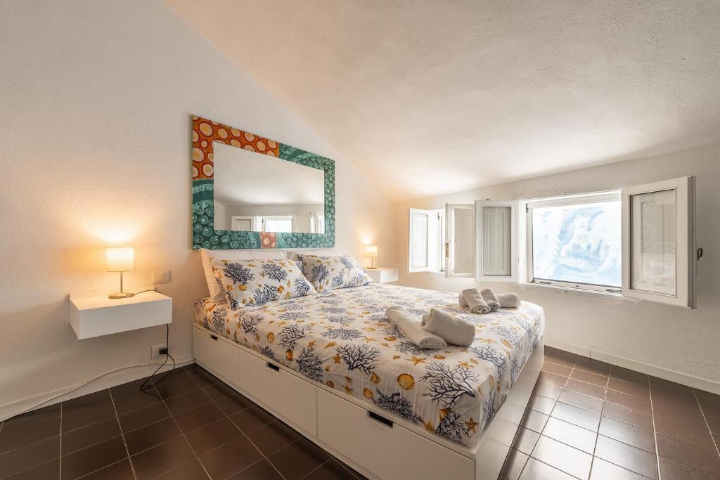 Postel nebo postele na pokoji v ubytování Casa Arcobaleno Carloforte