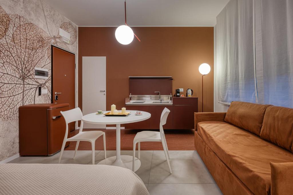 a living room with a couch and a table and chairs at Via Fiasella - Le Case di Bart in Genoa