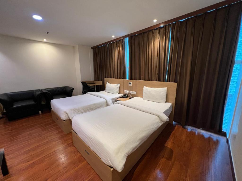 Postel nebo postele na pokoji v ubytování Hyphen Business Hotel