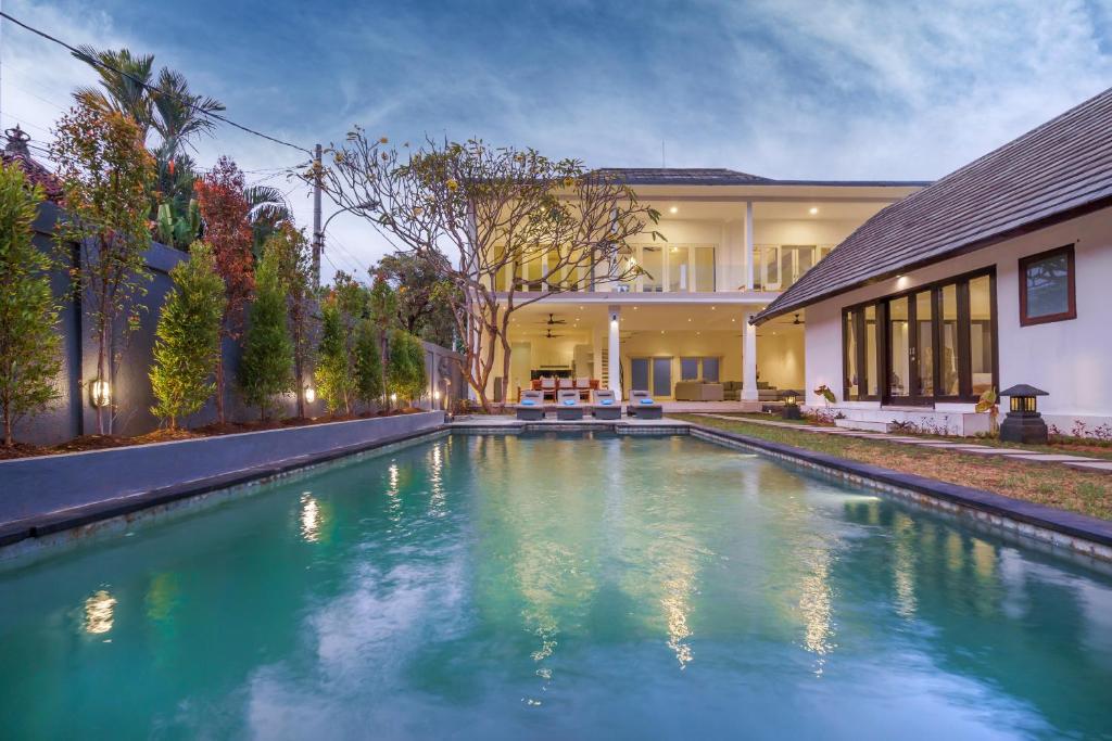 a swimming pool in the backyard of a house at Olivia Estate by Villas Direct Bali in Seminyak