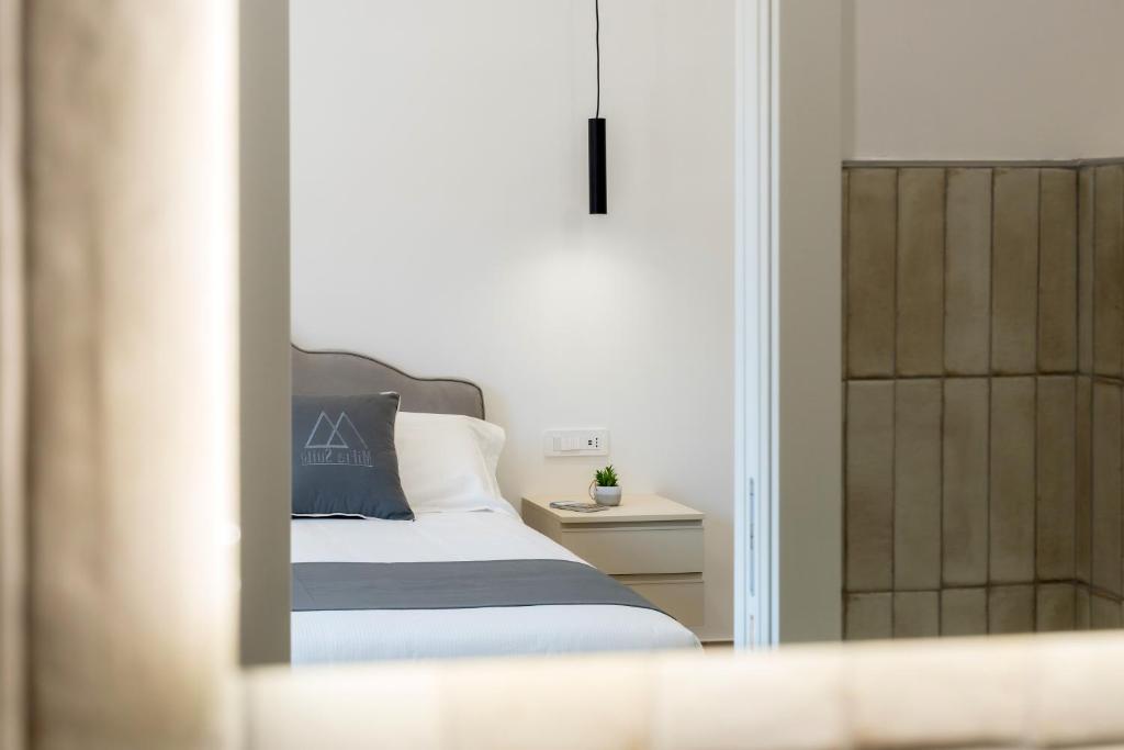 Postel nebo postele na pokoji v ubytování MIFRA SUITES