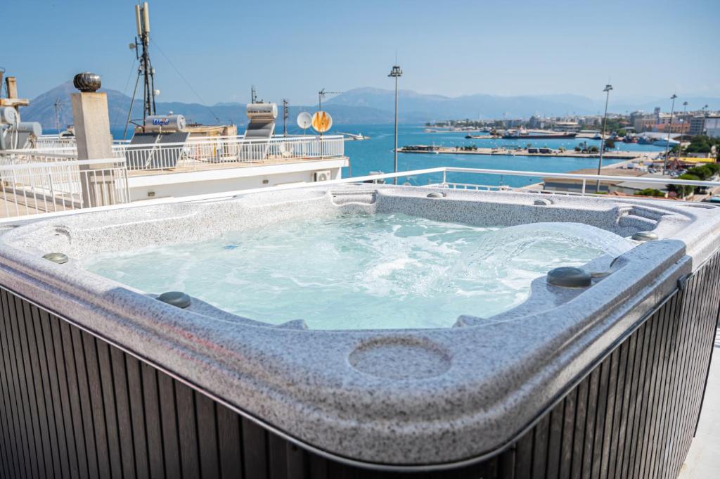 a hot tub on the balcony of a building at Vip penthouse patra in Patra