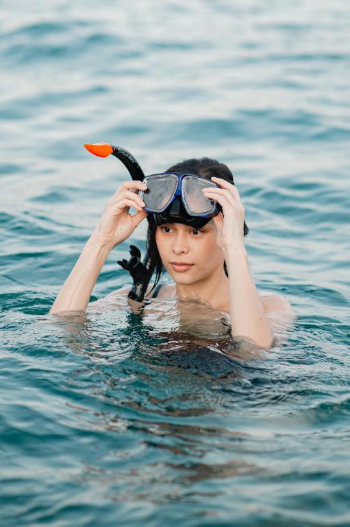 a woman is in the water with a goggles on at Ao Cho Grandview Hideaway Resort in Ko Samed