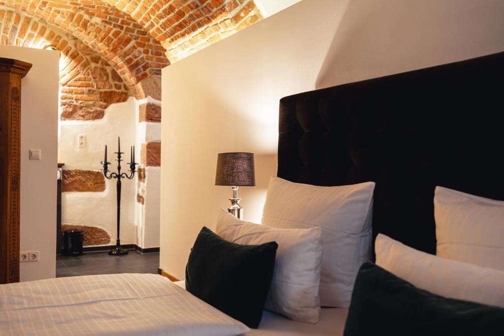 a bedroom with a bed with white pillows at Historical Luxury Homes - Luxus Suite Colloseum in Freiburg im Breisgau