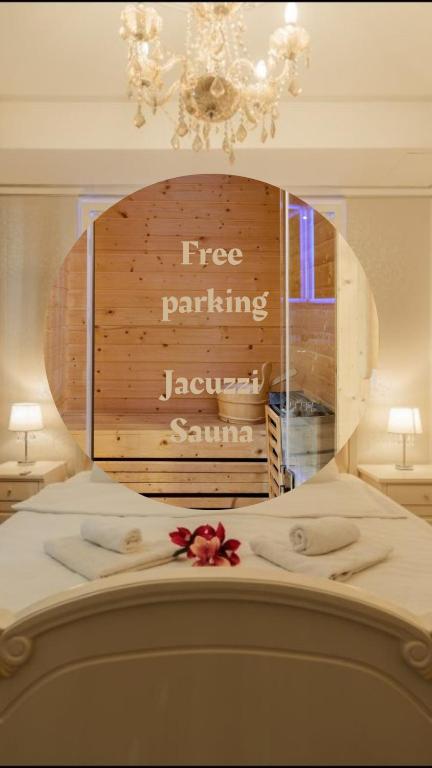 a bed with a sign that reads free parking javascript santa at Spa Lux Apartmani in Novi Sad