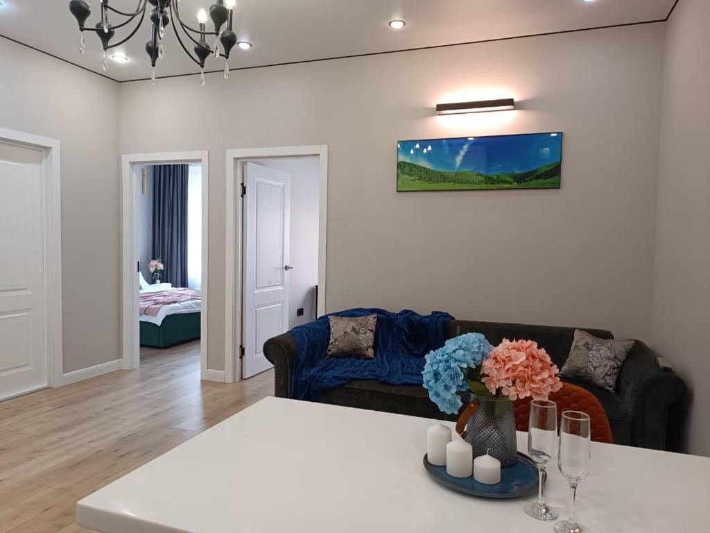 a living room with a couch and a table at Riviera apartment for 6 persons in Almaty
