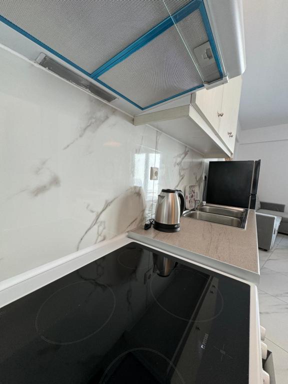 a kitchen with white marble countertops and a sink at Anemos Naxos town suites-apartment in Naxos Chora