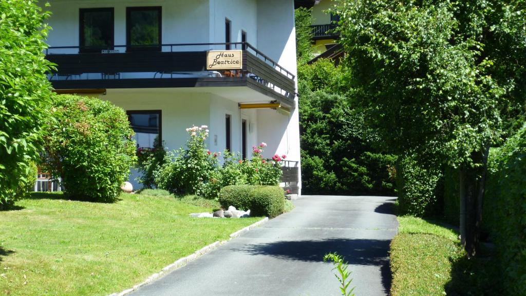 a dog laying on the grass next to a house at Haus Beatrice in Kitzbühel