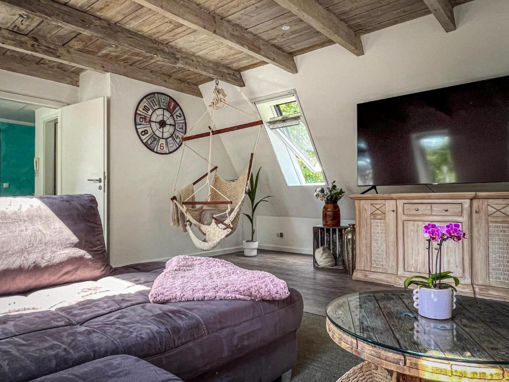 a living room with a couch and a glass table at Anrena Forest in Voßmoor