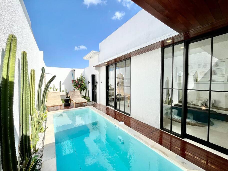 a swimming pool in the backyard of a house at 2BR Villa The Three Cactuses Stylish Mediteranian 5mins to Sanur Beach in Sanur