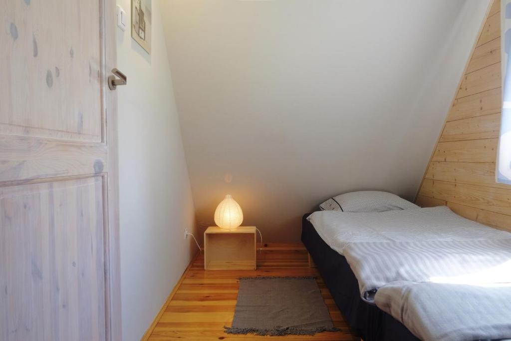 Postel nebo postele na pokoji v ubytování Domek Drewniany