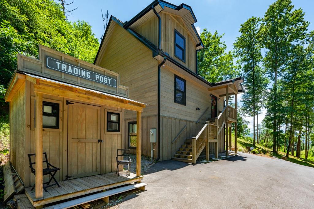 a house with a sign that reads trading first at Lil Cabin in the Cove! MTN views, theater, hot tub, games, king beds, Prime Location! in Sevierville
