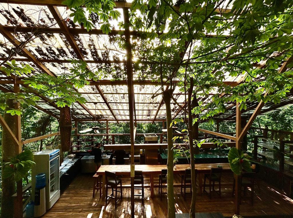 a greenhouse with a table and chairs and trees at ZÂRIA Hotel & Retreat Center in El Valle