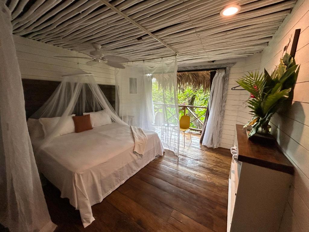 a bedroom with a white bed with a canopy at ZÂRIA Hotel & Retreat Center in El Valle