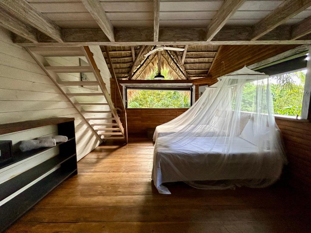 a bedroom with a bed with a mosquito net at ZÂRIA Hotel & Retreat Center in El Valle