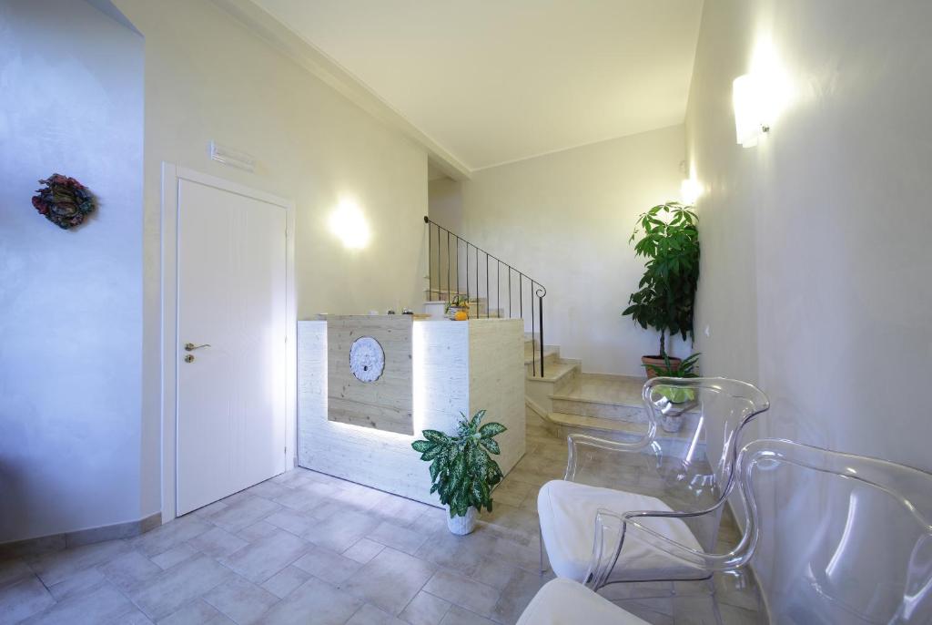a bathroom with a sink and a staircase with plants at Casal Sikelio in Cassibile