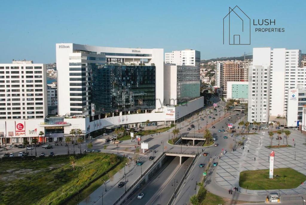 a city with a busy street in front of buildings at LUXURY Hilton City Center residence 5A GUEST FRIENDLY in Tangier
