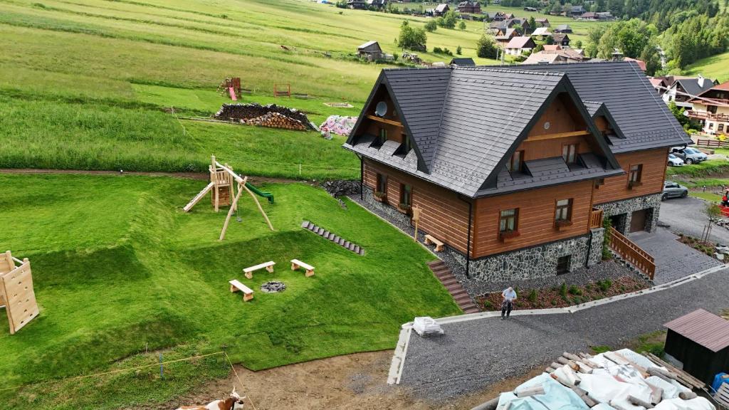 a model of a house with a playground at Apartmány Lúčny Raj in Ždiar