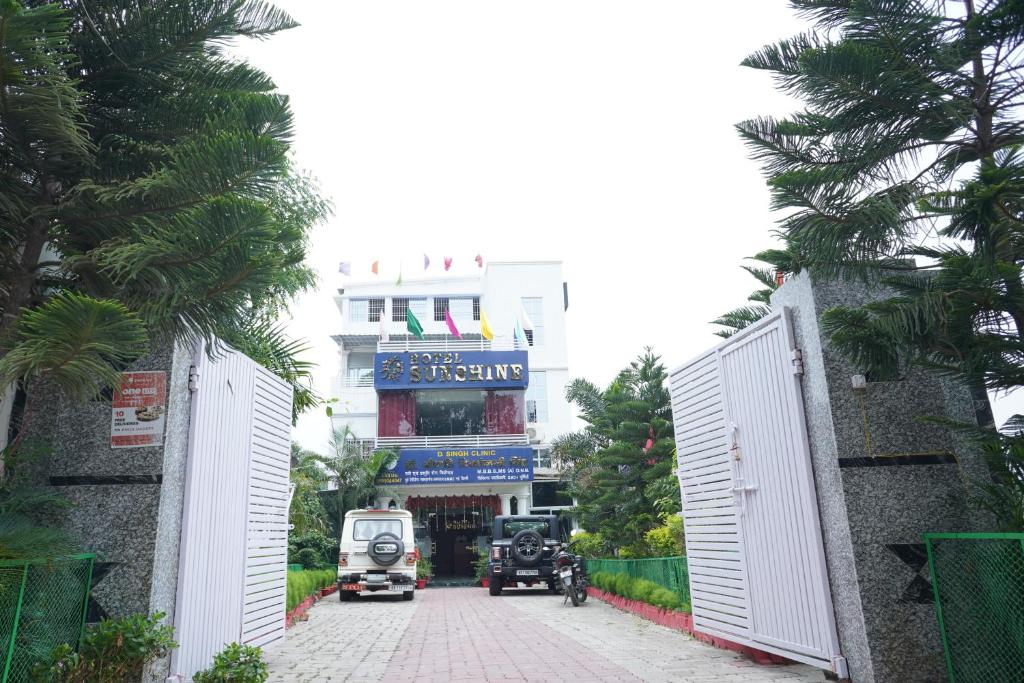 a building with a gate in front of a street at Hotel sunshine & restaurant in Pūrnia
