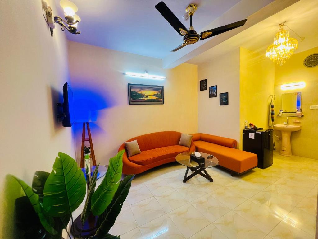 a living room with a couch and a table at Cafe Green Valley in Rangpur
