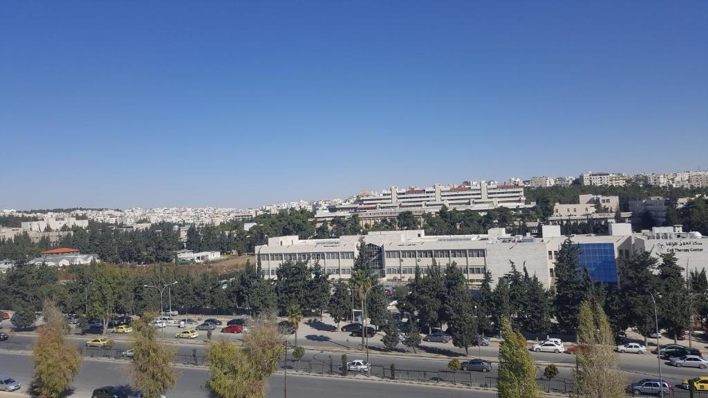 a view of a city with a parking lot at Al Khaleej Hotel Apartments in Amman