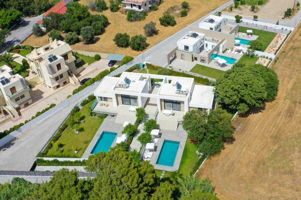 an aerial view of a large white house at Aurum Villas in Ialyssos