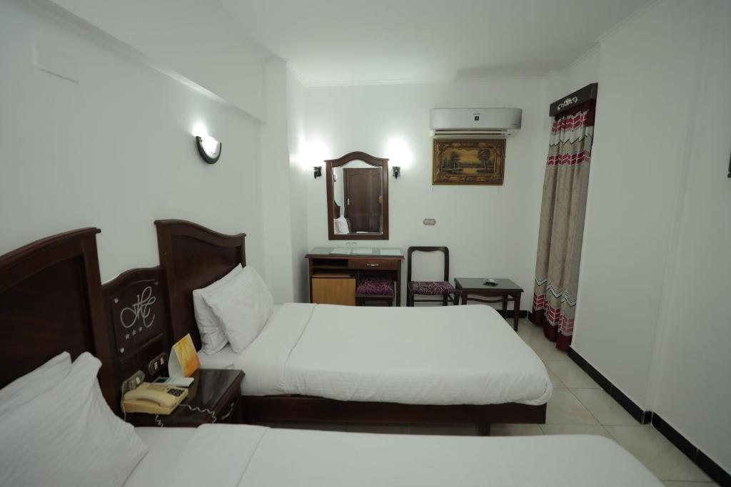 Postel nebo postele na pokoji v ubytování Happy City Hotel