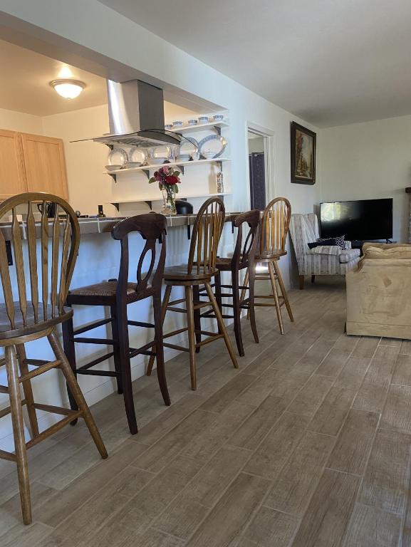 a kitchen and living room with a table and chairs at La Mesa House, a large modern home in Santa Barbara