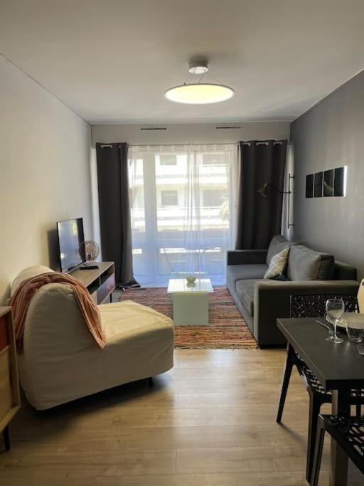 un salon avec un canapé et une table dans l'établissement grand studio de 28 m2 plein centre de Canet plage, à Canet