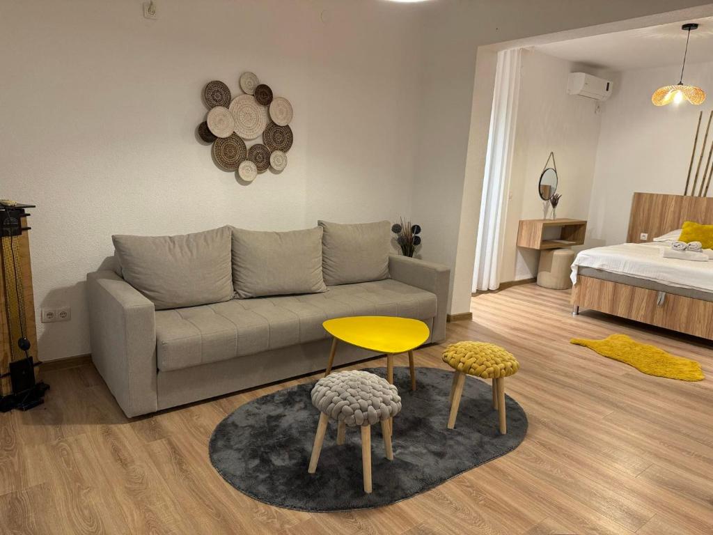 a living room with a couch and a yellow table at Apartments Casa Pineta in Ulcinj