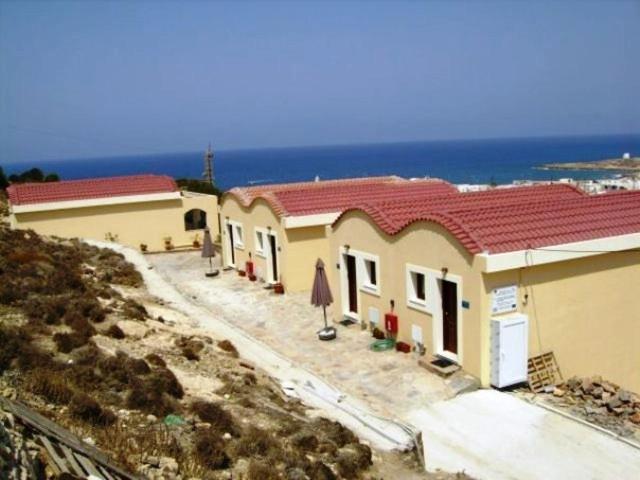 a group of buildings on a hill next to the ocean at Galanou View in Frý