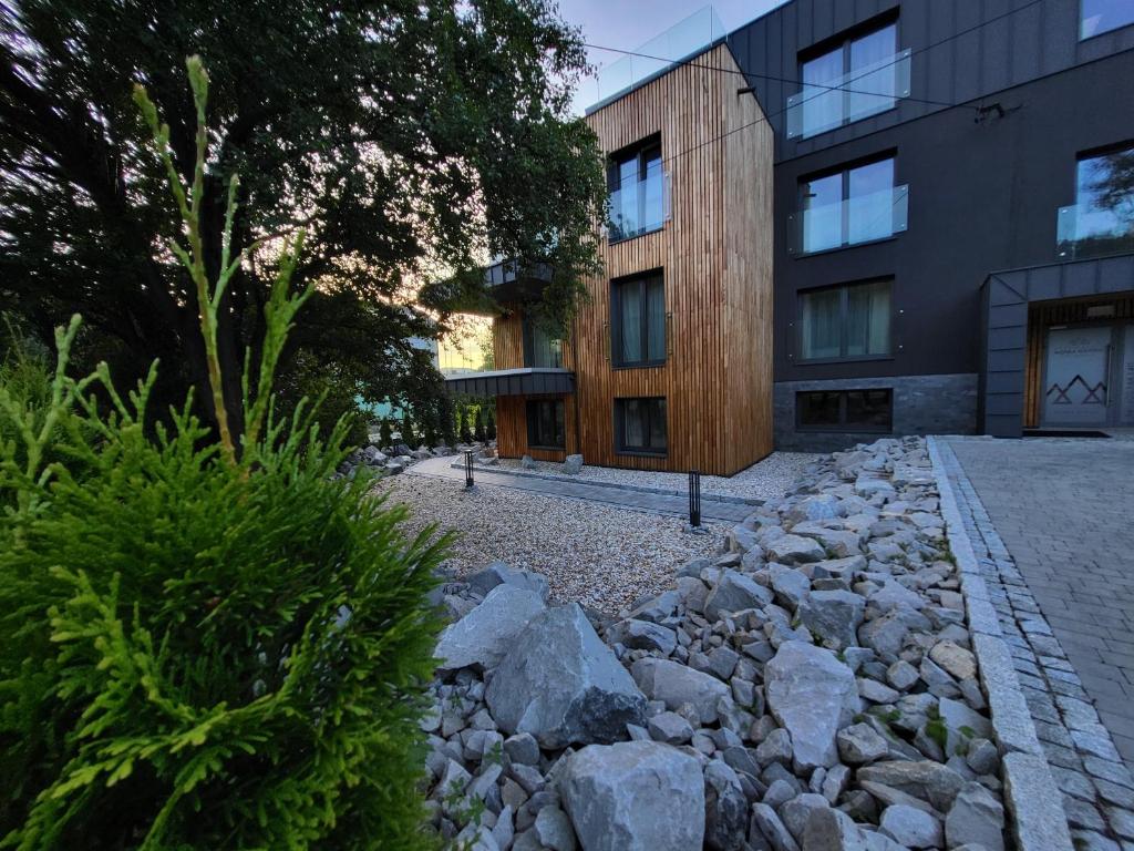 a stone path in front of a building at Apartamenty Nowa Osada - by VillaOlimpijska2 in Wisła