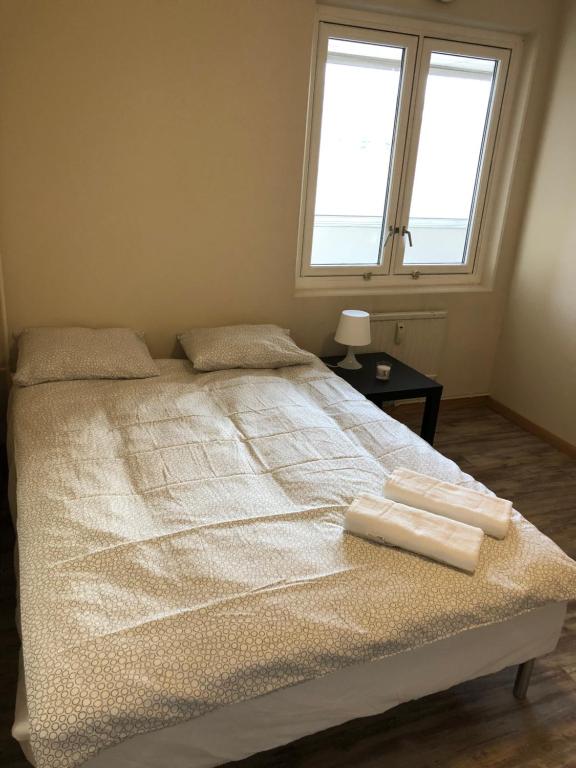 a bedroom with a bed with two towels on it at Centrum Box in Oslo