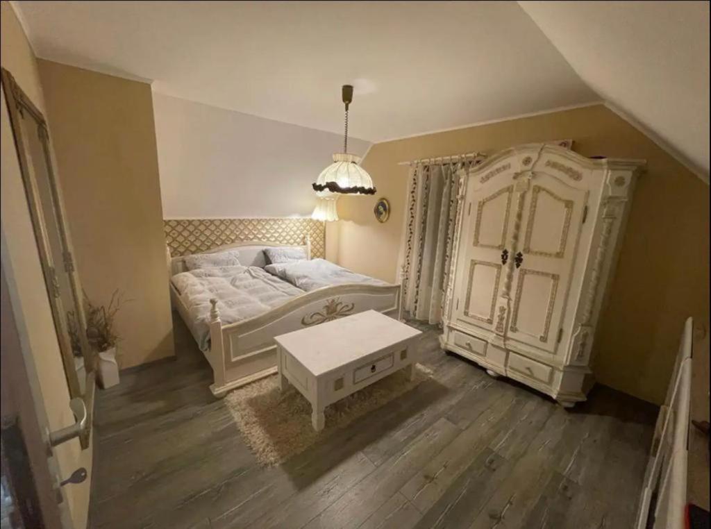 a bedroom with a bed and a large cabinet at Cabana Ade in Mada