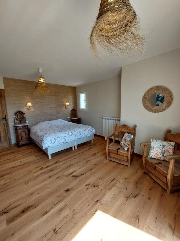 une chambre avec un lit et un parquet dans l'établissement Quiétude Provençale, à Mons