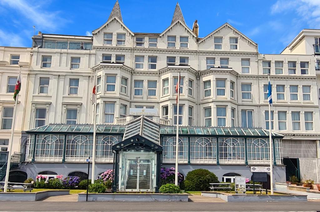 a large white building with a statue in front of it at The Empress Hotel in Douglas