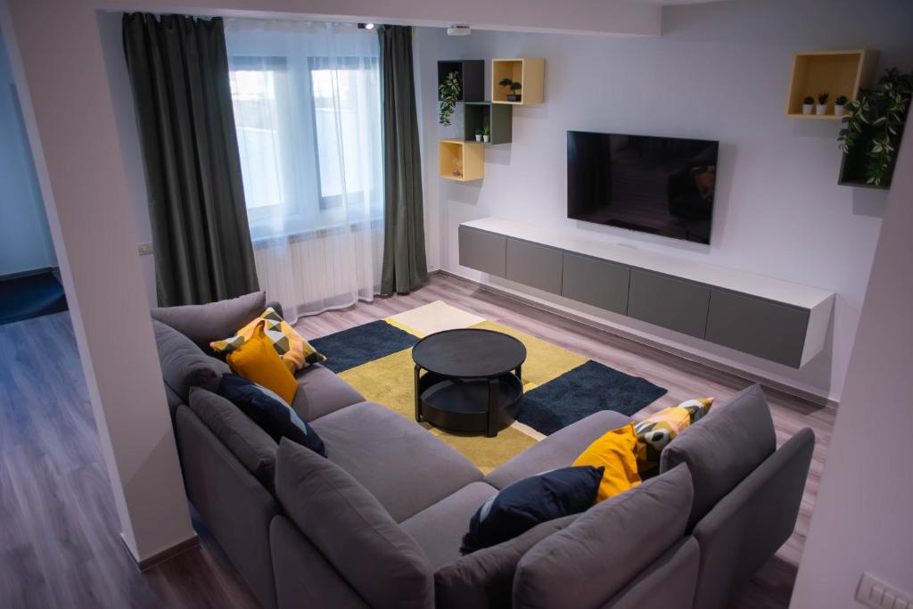 a living room with a couch and a tv at Vila Happy Busteni in Buşteni