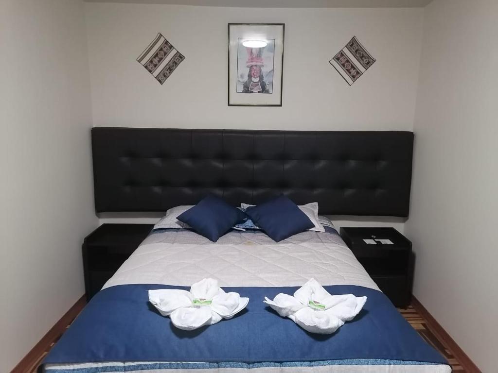 Postel nebo postele na pokoji v ubytování Hostal San Antonio Inn
