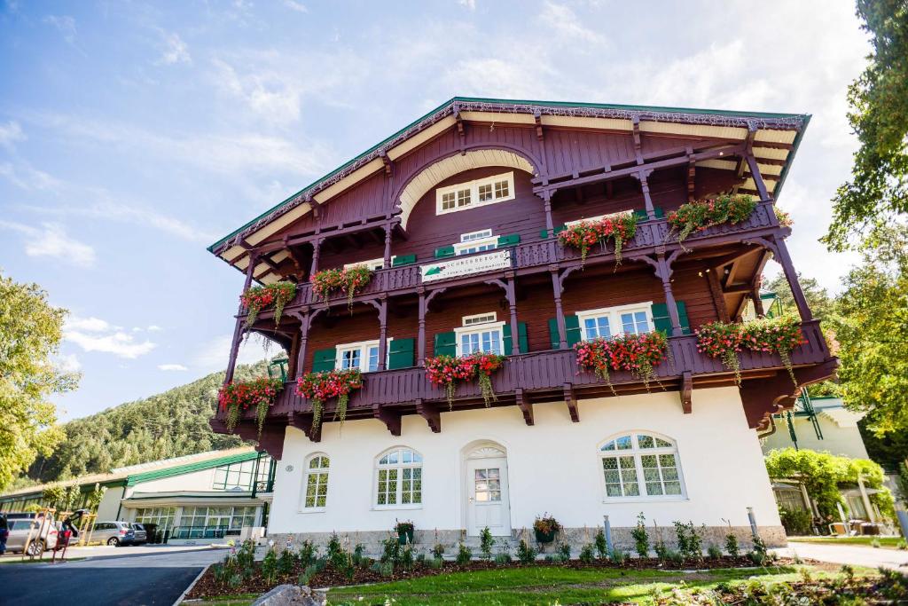 a building with balconies on the side of it at Hotel Schneeberghof in Puchberg am Schneeberg