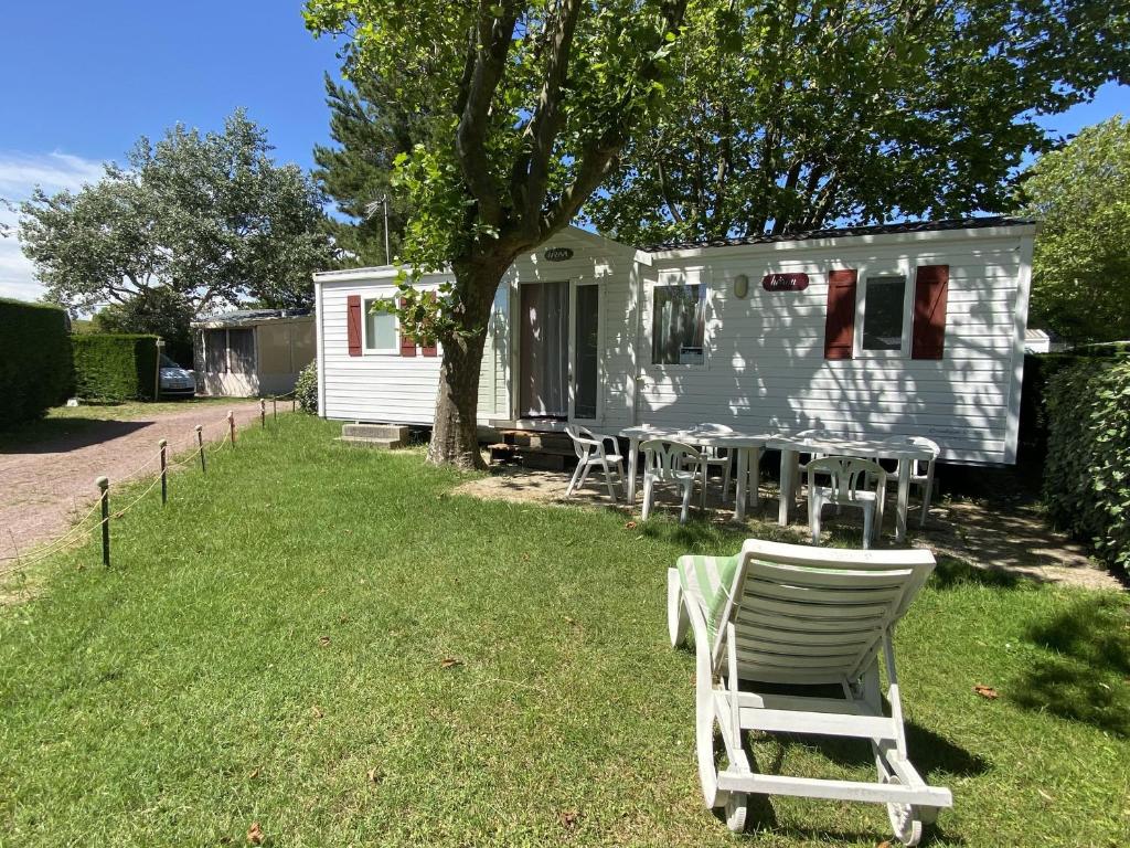 une table et des chaises devant une remorque dans l'établissement Mobil-home 3 chambres proche plage à Fouras, idéal 6 pers., équipement complet, calme assuré. - FR-1-709-68, à Fouras