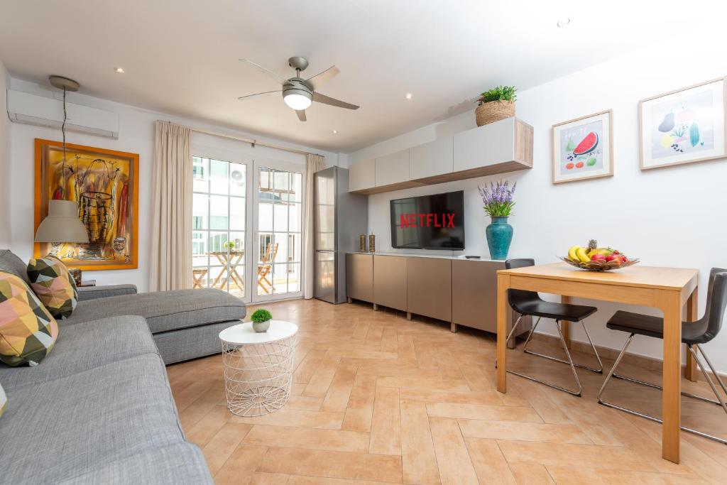 a living room with a couch and a table at Calas Beach Corralejo in Corralejo