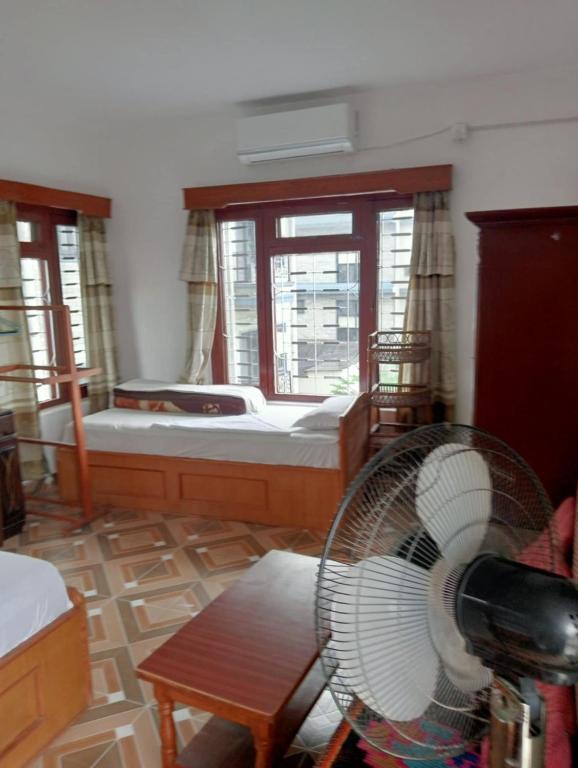 Ένα ή περισσότερα κρεβάτια σε δωμάτιο στο New Summit Guest House