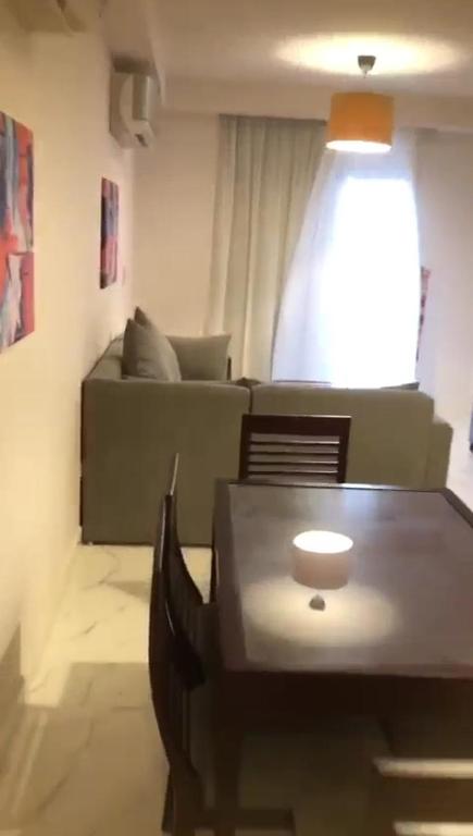 a living room with a table and a couch at Porto golf marina in El Alamein