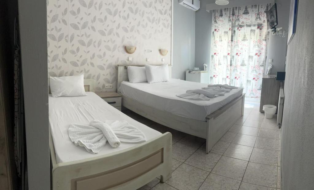 Postel nebo postele na pokoji v ubytování Ellas Hotel