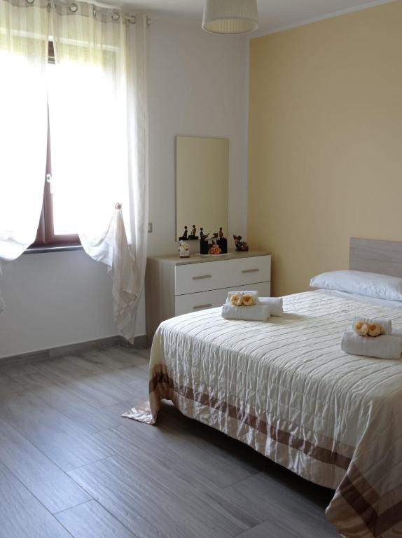 a bedroom with a bed with a dresser and a mirror at B&B Villa Rosa new in SantʼAntonio Abate